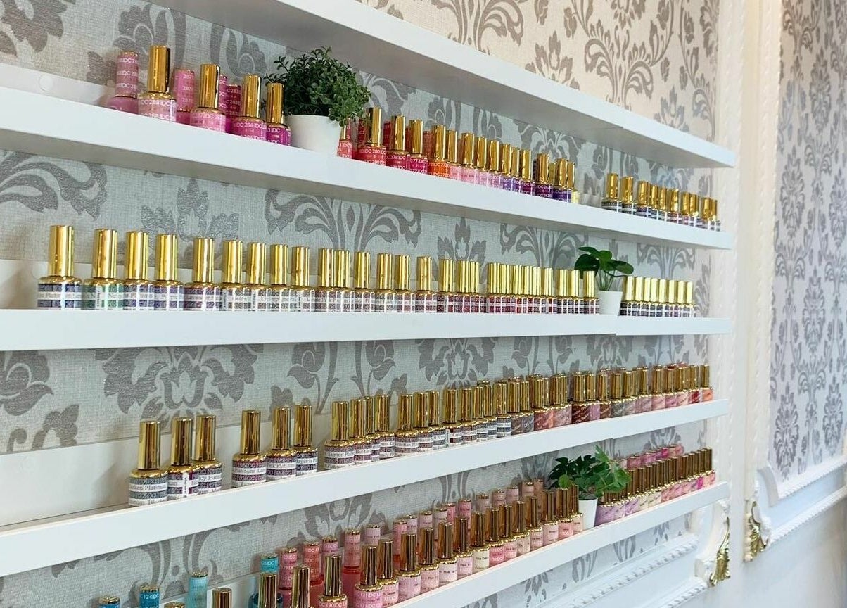 Nail polish collection at Lemon Hand and Foot Spa, Dublin, County Wicklow, IE, displayed on elegant shelves.