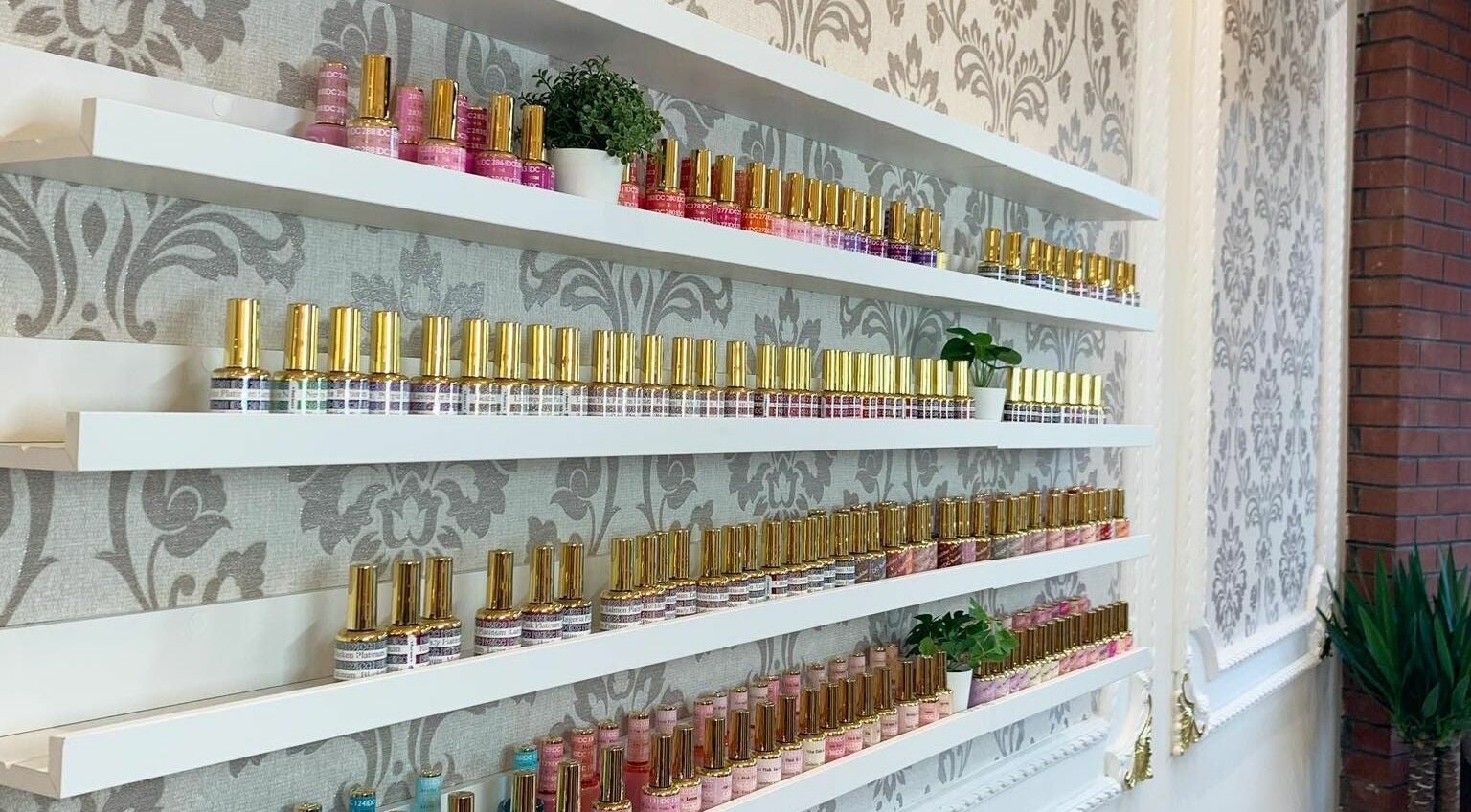 Nail polish collection at Lemon Hand and Foot Spa, Dublin, County Wicklow, IE, displayed on elegant shelves.