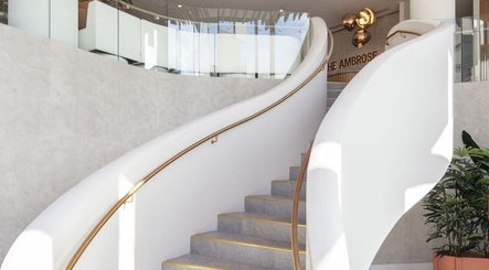 Elegant spiral staircase at SYLKSKIN Milton, Queensland, AU, embodying modern design and sophistication.