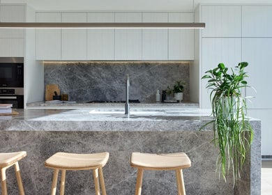 Stylish stone kitchen at SYLKSKIN Milton, Queensland, AU showcases modern elegance and natural decor.