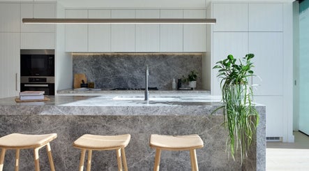 Stylish stone kitchen at SYLKSKIN Milton, Queensland, AU showcases modern elegance and natural decor.