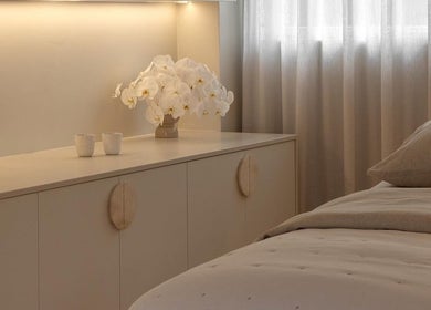 Elegant spa room at Joanna Newham Skin Health, Avalon Beach, New South Wales, AU with soft lighting and orchids.