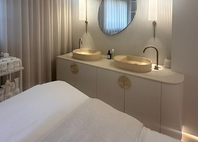 Elegant treatment room at Joanna Newham Skin Health, Avalon Beach, New South Wales, AU, with twin sinks and products.