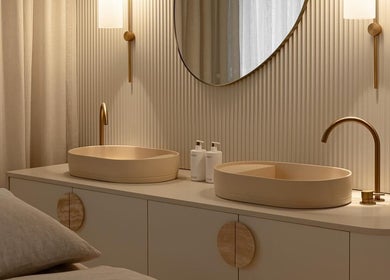 Chic vanity at Joanna Newham Skin Health, Avalon Beach, New South Wales, AU showcasing dual sinks and gold fixtures.