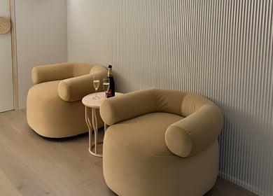 Elegant seating area in Joanna Newham Skin Health, Avalon Beach, New South Wales, AU, with plush chairs and drinks.