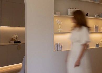 Elegant interior of Joanna Newham Skin Health, Avalon Beach, New South Wales, AU, showcasing lit shelves and decor.