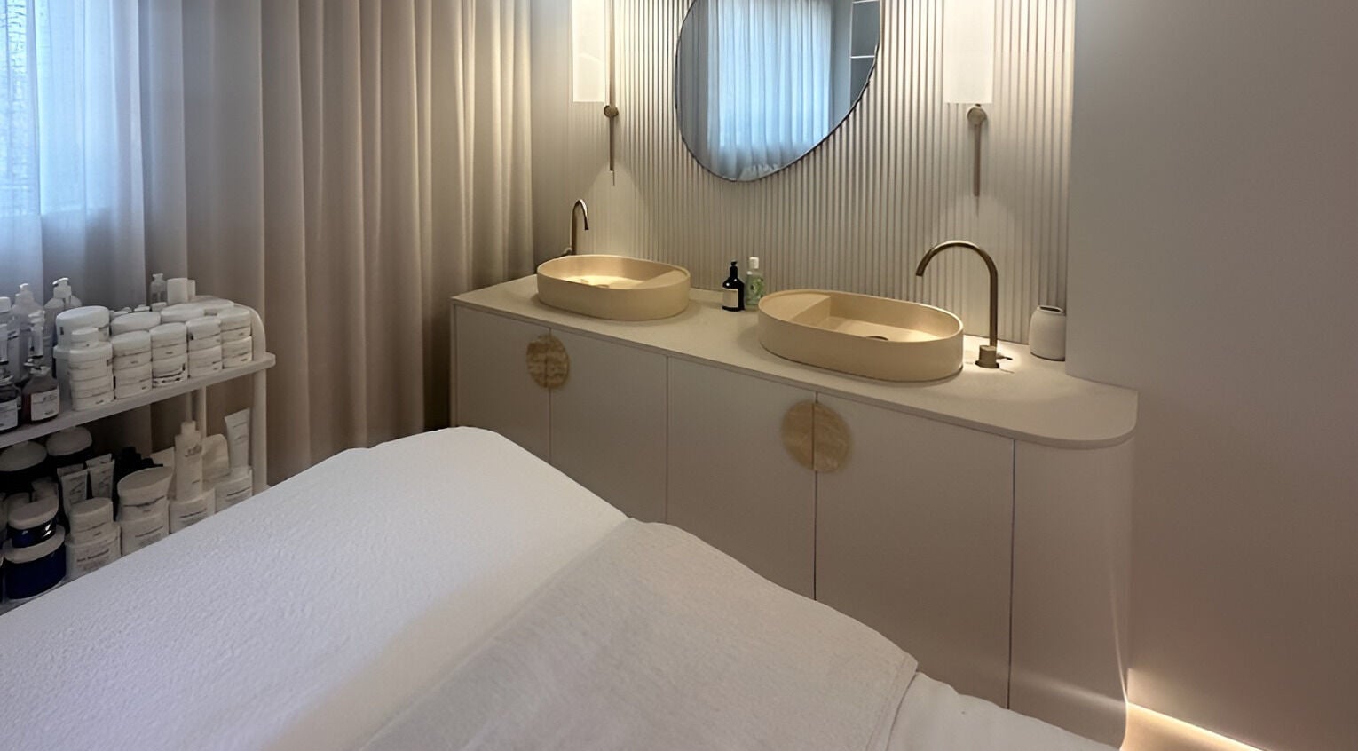 Luxurious treatment room at Joanna Newham Skin Health, Avalon Beach, New South Wales, AU. Double sinks and plush bed.