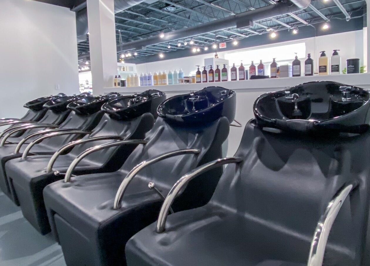 Modern hair wash stations at Studio LaSalle, DENTON, United States, US, showcasing elegance and functionality.