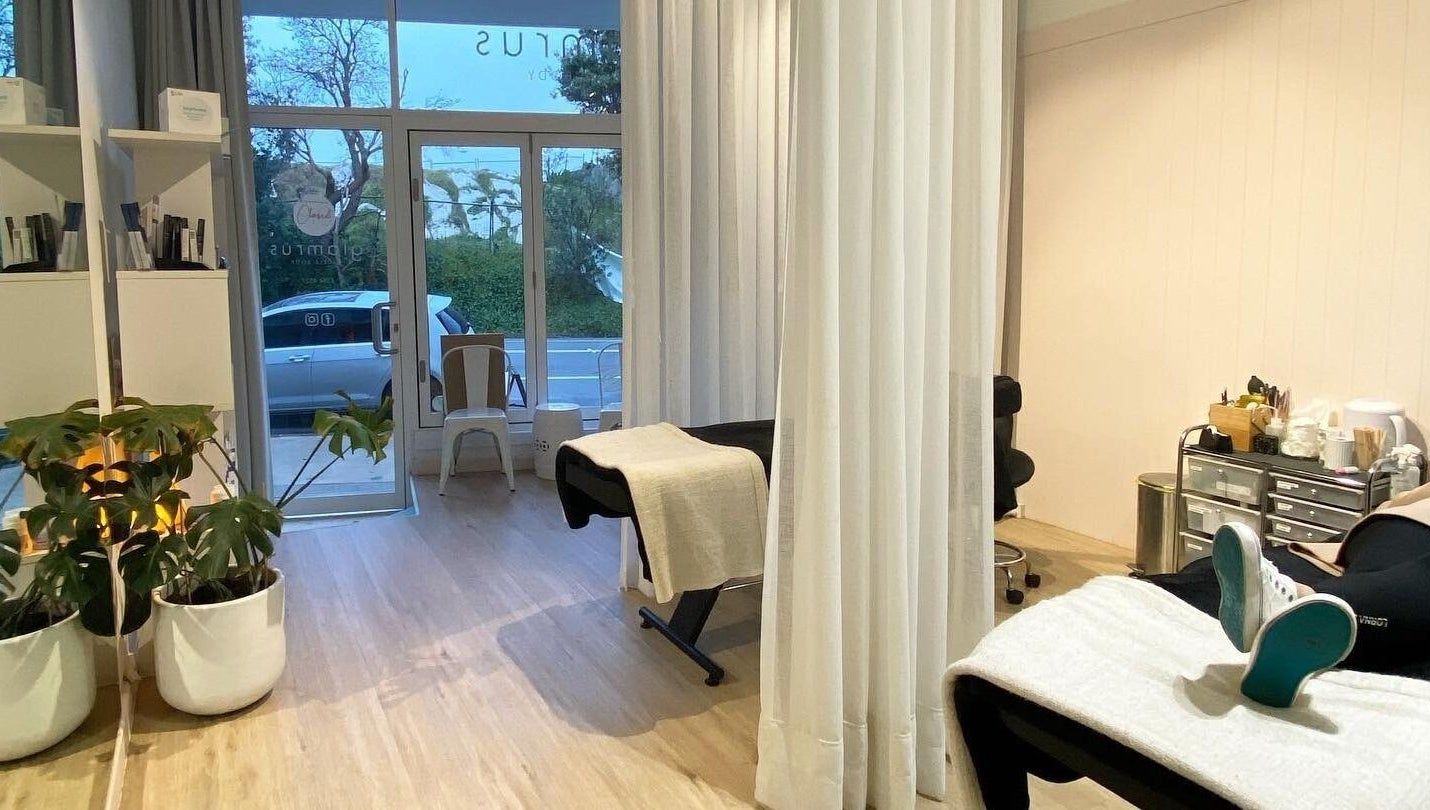 Relaxing interior of Glam R Us Face and Body in Terrigal, New South Wales, featuring treatment beds and plants.