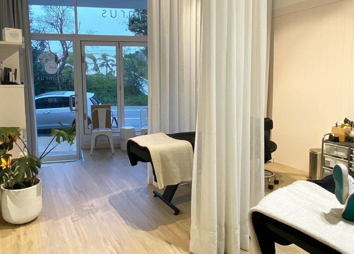 Relaxing interior of Glam R Us Face and Body in Terrigal, New South Wales, featuring treatment beds and plants.