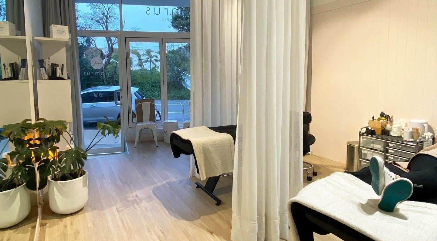 Relaxing interior of Glam R Us Face and Body in Terrigal, New South Wales, featuring treatment beds and plants.