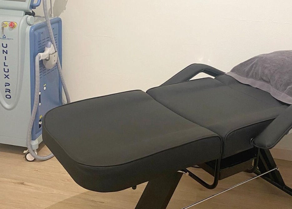 Modern treatment room at Glam R Us Face and Body, Terrigal, New South Wales, AU featuring sleek chair and equipment.