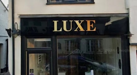 Front view of LUXE Beauty in Long Stratton, England, GB showcasing elegant black and gold signage.