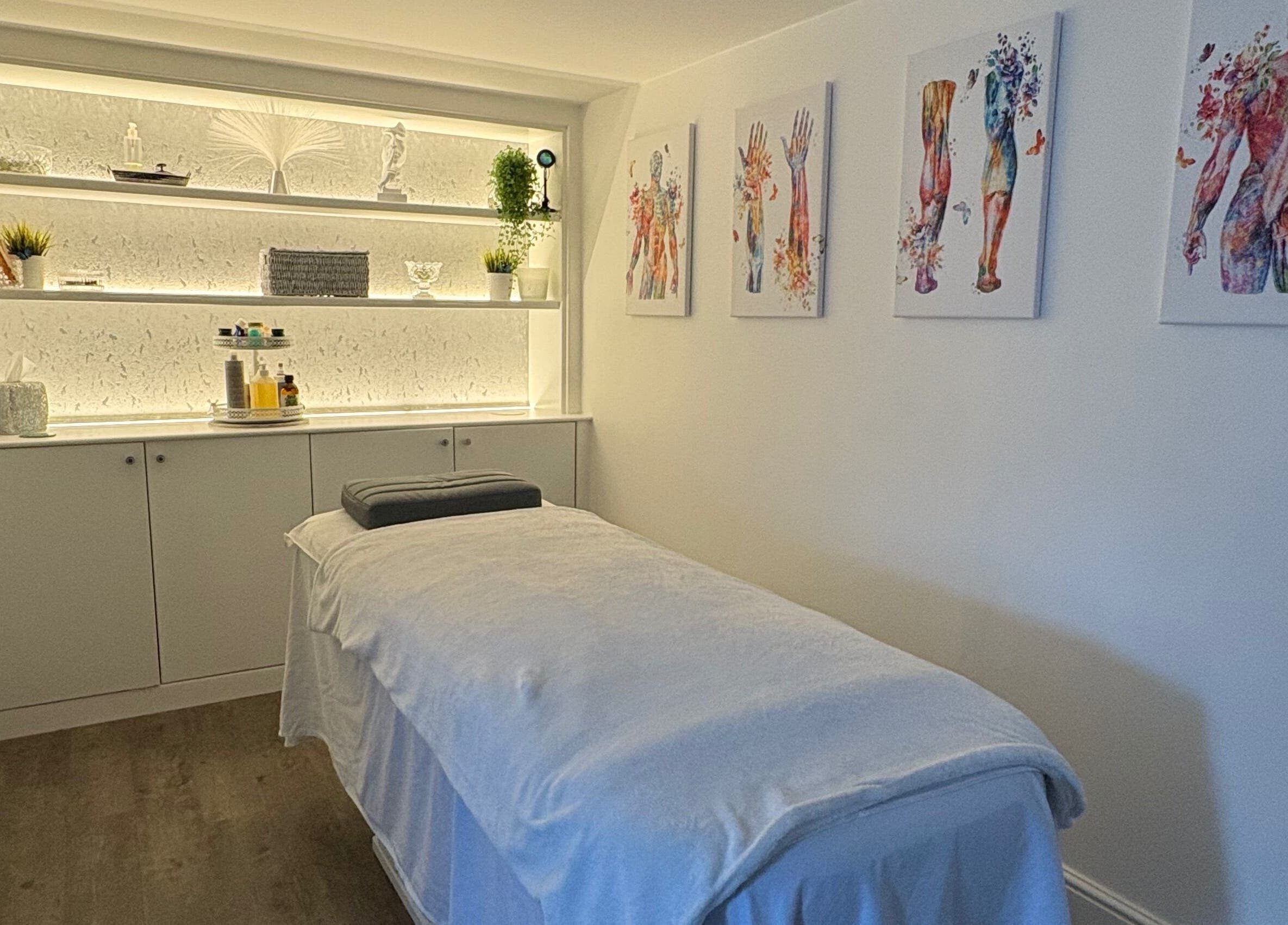 Relaxing massage room at BodyLogic, Higham Ferrers, GB with soothing decor and elegant artwork.