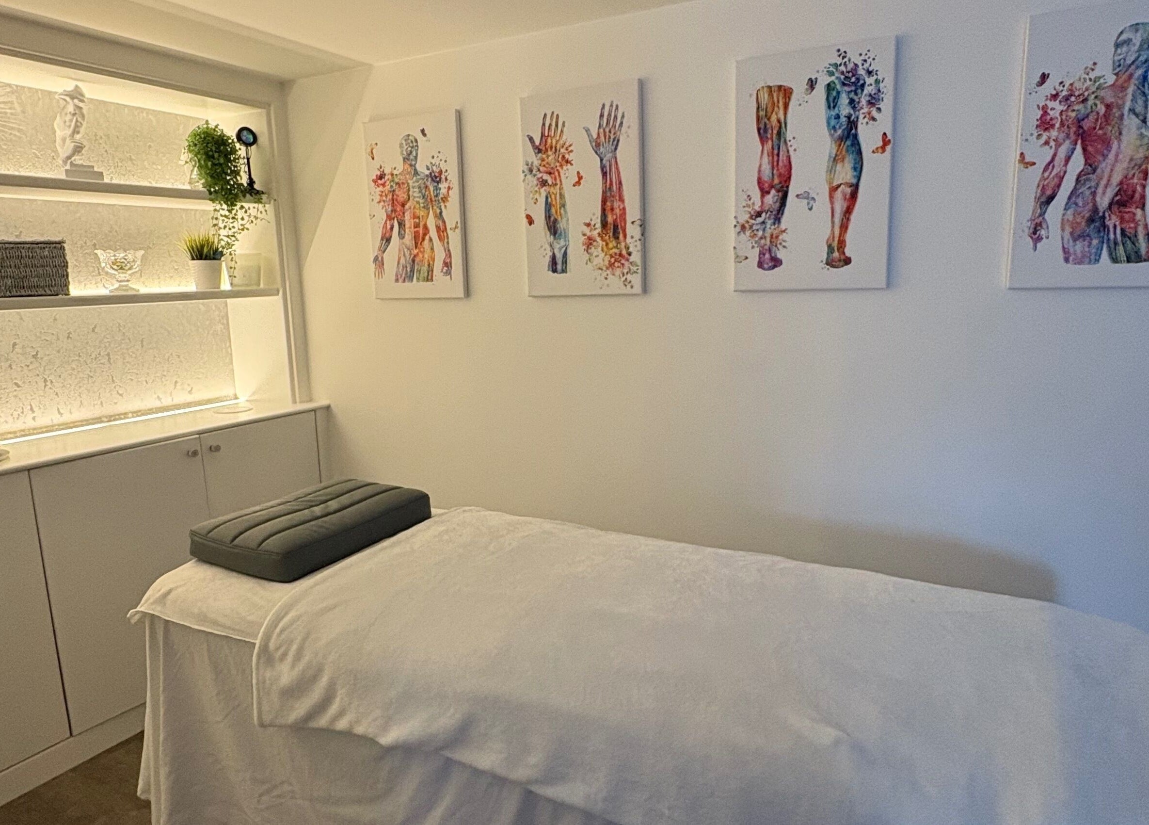 Relaxing treatment room at BodyLogic, Higham Ferrers, GB, with calming decor and therapy bed.