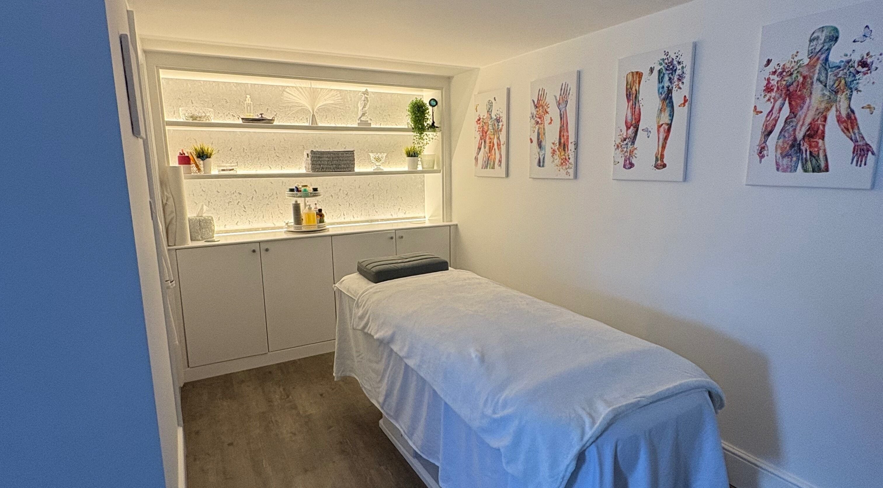 Relaxing treatment room at BodyLogic, Higham Ferrers, GB, featuring a cozy massage bed and calming decor.