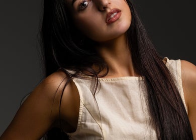 A serene woman with long hair at KK Artistry in Limerick, County Limerick, IE, showcasing natural beauty.