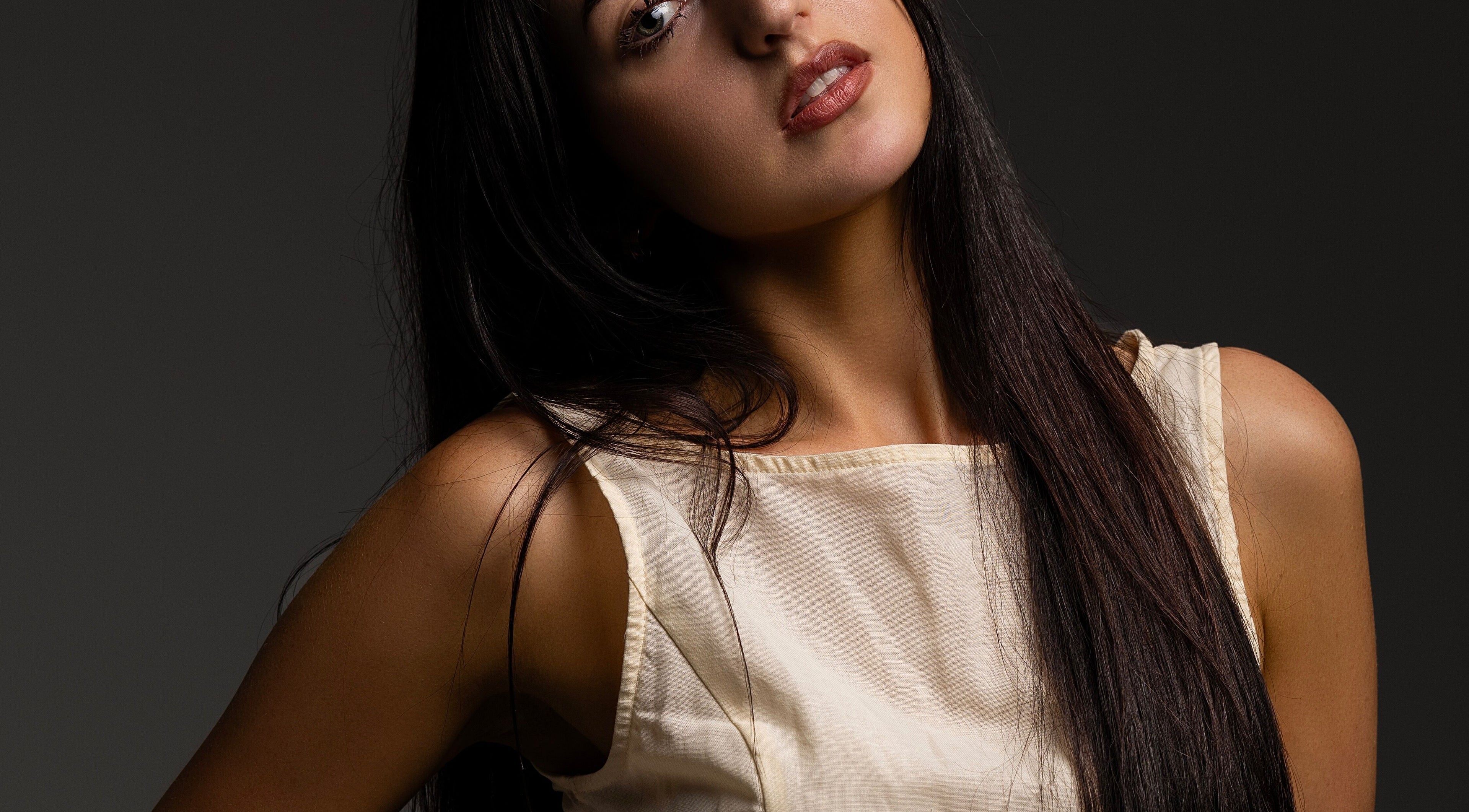 A serene woman with long hair at KK Artistry in Limerick, County Limerick, IE, showcasing natural beauty.