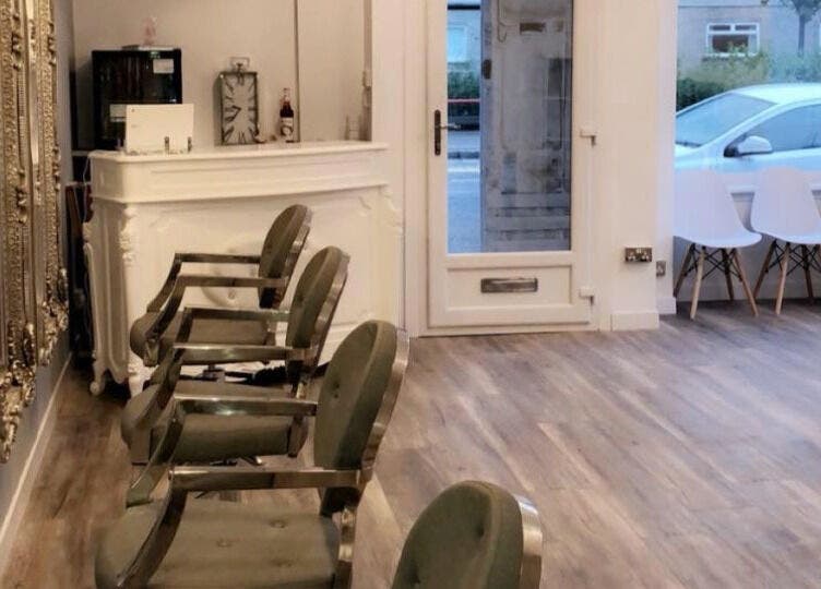 Elegant interior of The salon Tillicoultry in Tillicoultry, Scotland, GB with ornate mirrors and modern seating.