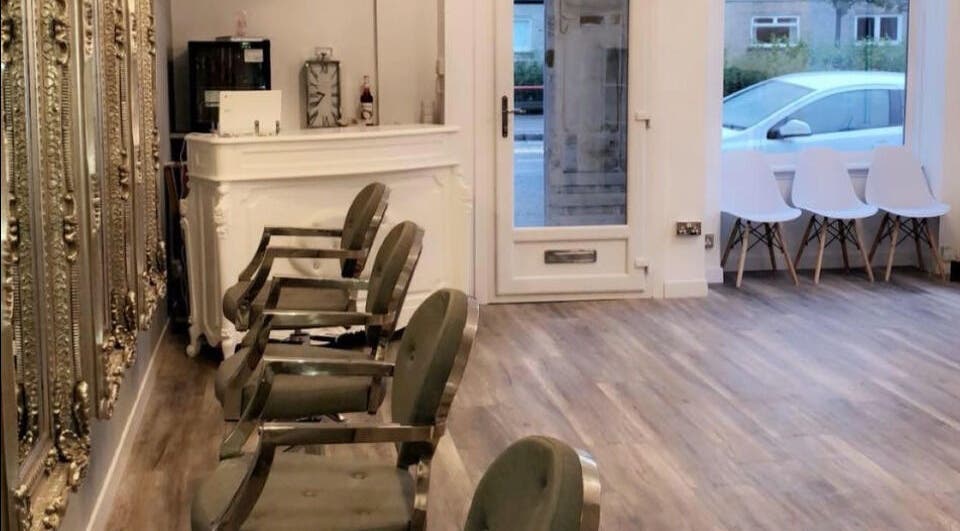 Elegant interior of The salon Tillicoultry in Tillicoultry, Scotland, GB with ornate mirrors and modern seating.