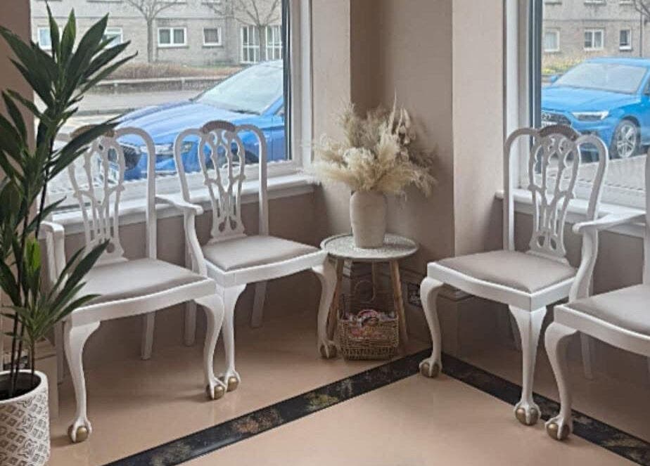 Chic waiting area at The salon Tillicoultry, Tillicoultry, Scotland, GB with white chairs and decor.