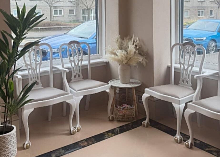 Chic waiting area at The salon Tillicoultry, Tillicoultry, Scotland, GB with white chairs and decor.