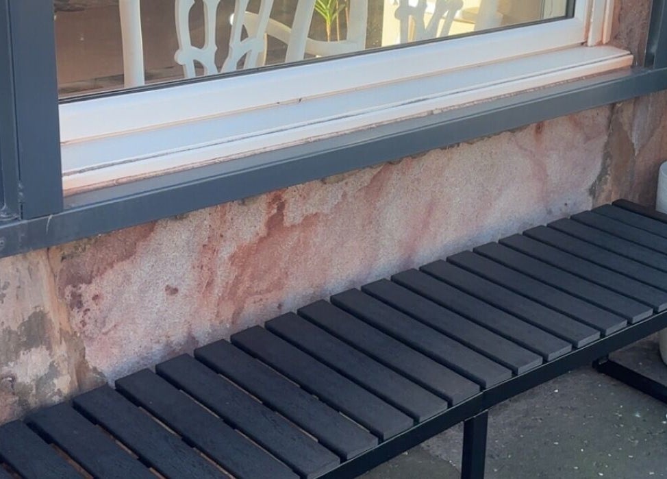 Outdoor black bench by the window of The salon Tillicoultry, Tillicoultry, Scotland, GB.