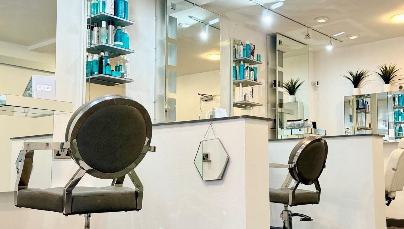 Modern salon interior at Bonds Aesthetics, The Royal Town of Sutton Coldfield, England, GB with sleek chairs and products.