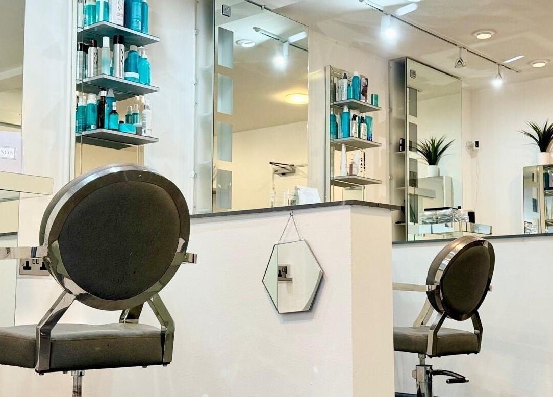 Modern salon interior at Bonds Aesthetics, The Royal Town of Sutton Coldfield, England, GB with sleek chairs and products.