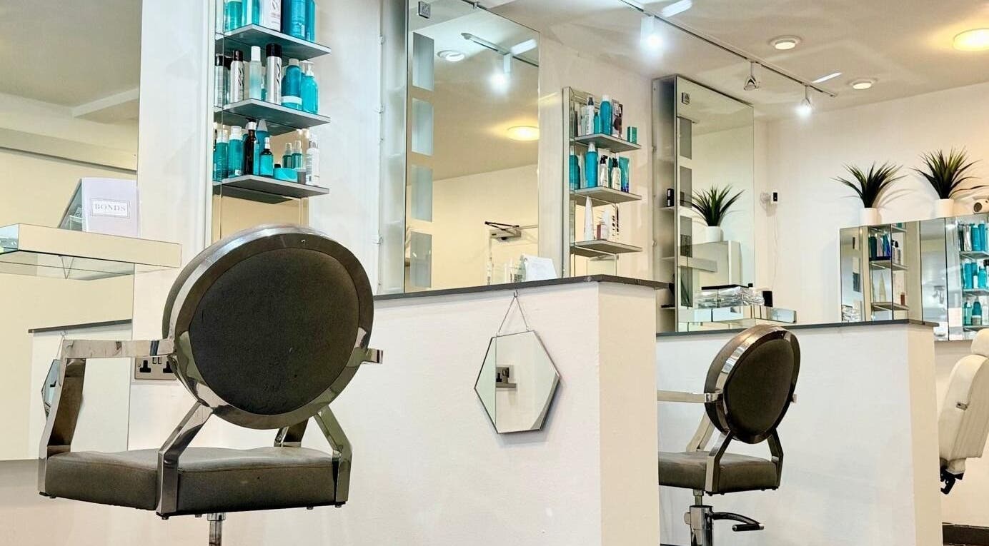 Modern salon interior at Bonds Aesthetics, The Royal Town of Sutton Coldfield, England, GB with sleek chairs and products.