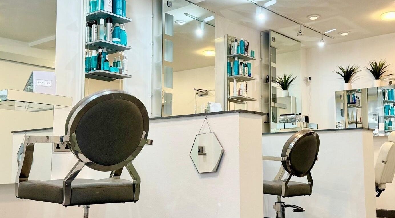 Modern salon interior at Bonds Aesthetics, The Royal Town of Sutton Coldfield, England, GB with sleek chairs and products.