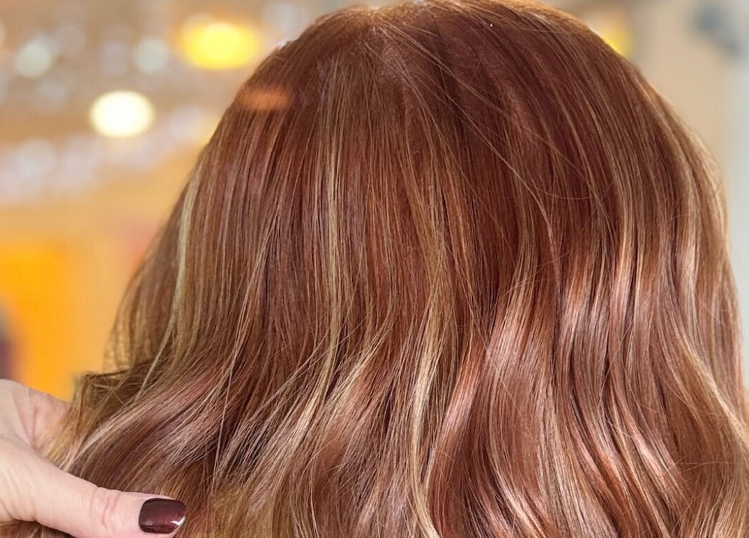 Rich cinnamon hair color styled in waves at Bonds Aesthetics, The Royal Town of Sutton Coldfield, England, GB.