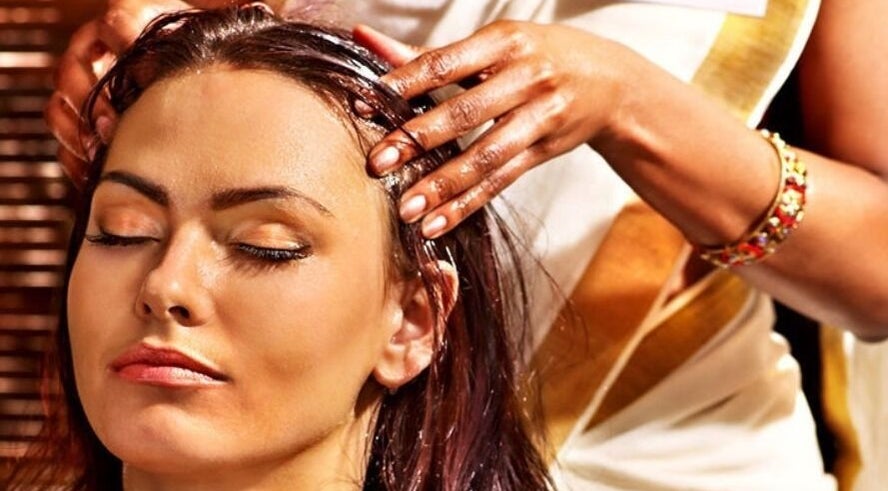 Calming head massage at Nadi's Beauty and Wellness, Melbourne, Victoria, AU, promoting relaxation and wellness.