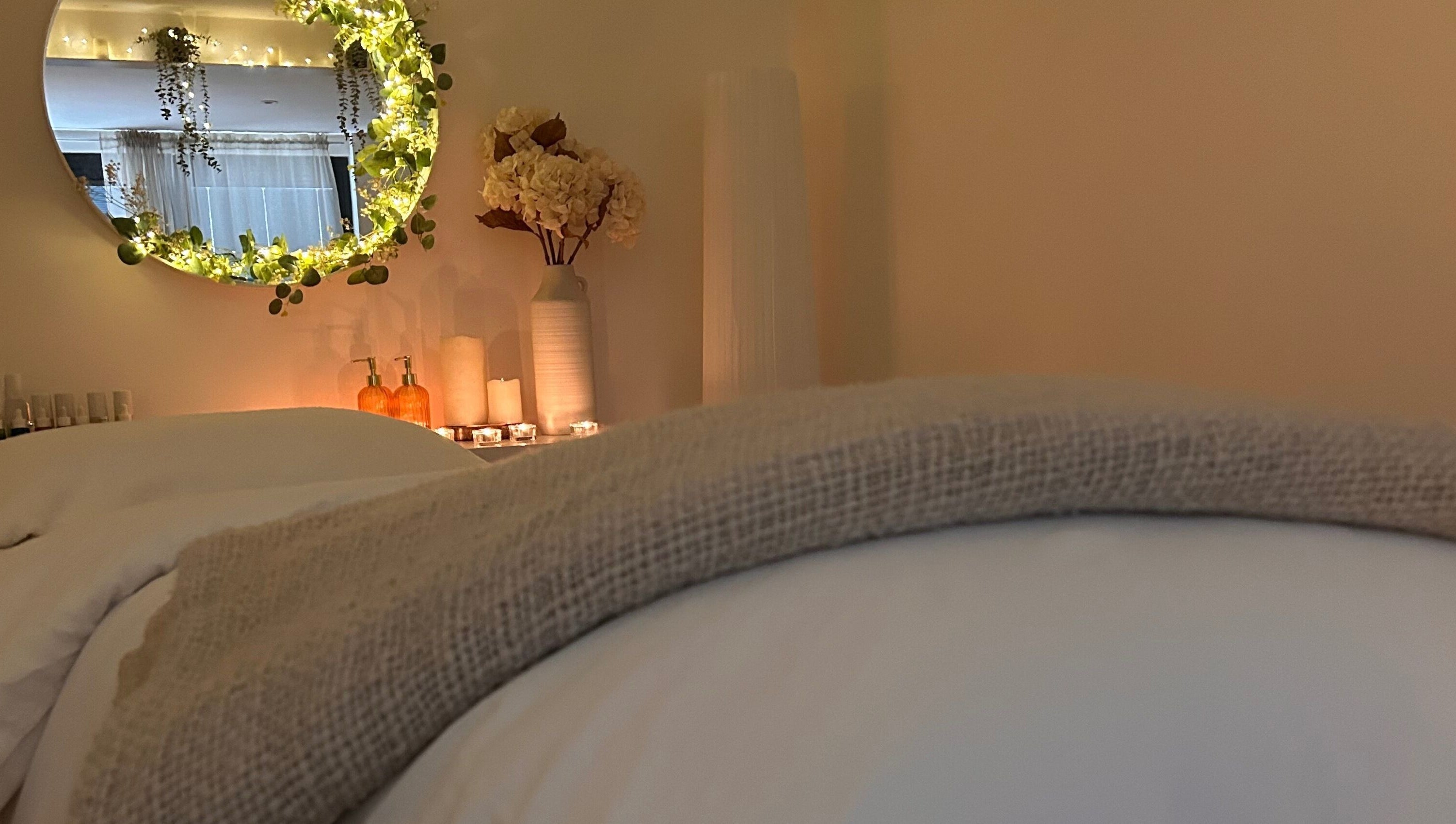 A cozy, tranquil spa room at Jill at No.3, Hale Barns, England, GB with soft lighting and floral decor.