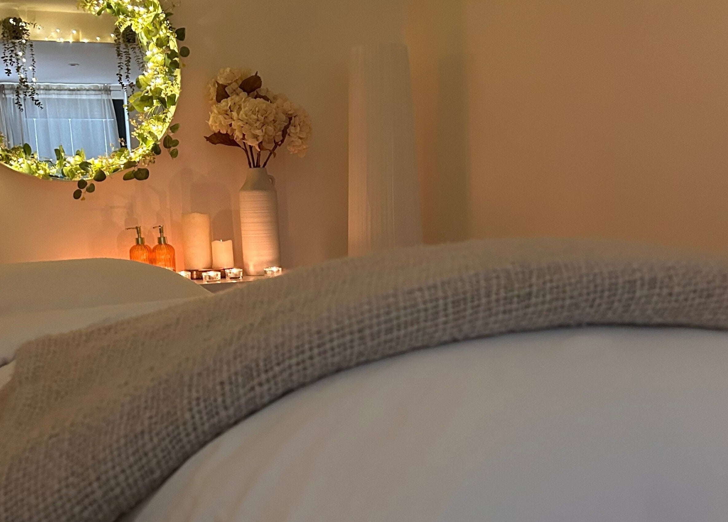A cozy, tranquil spa room at Jill at No.3, Hale Barns, England, GB with soft lighting and floral decor.