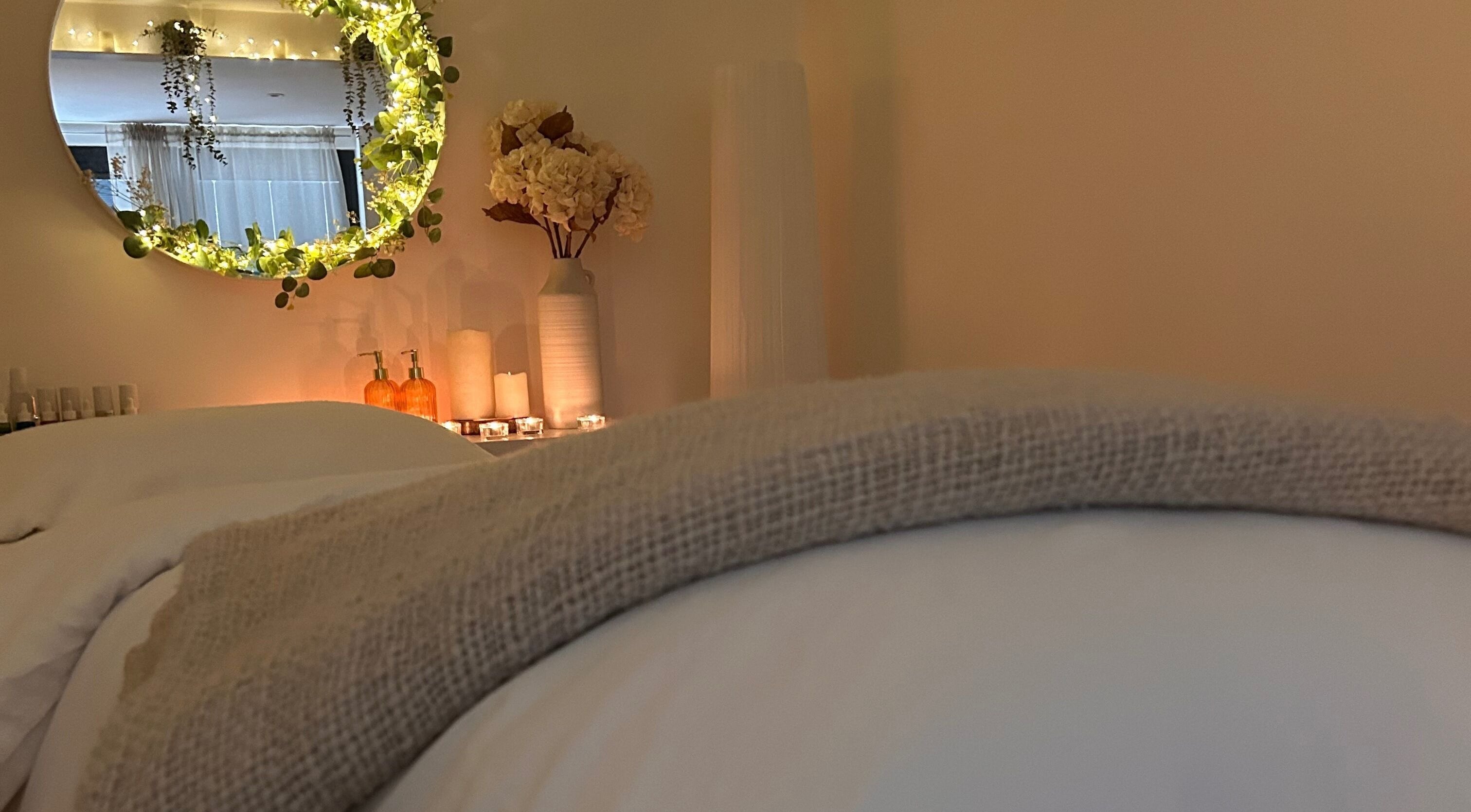 A cozy, tranquil spa room at Jill at No.3, Hale Barns, England, GB with soft lighting and floral decor.