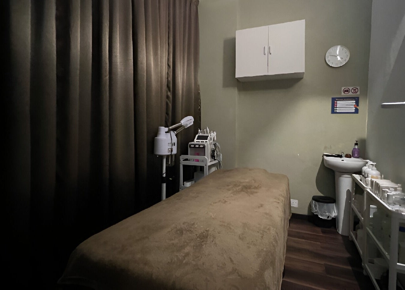 Calm treatment room at SK Men Spa (Shah Alam), Shah Alam, Selangor, MY with massage bed and equipment.