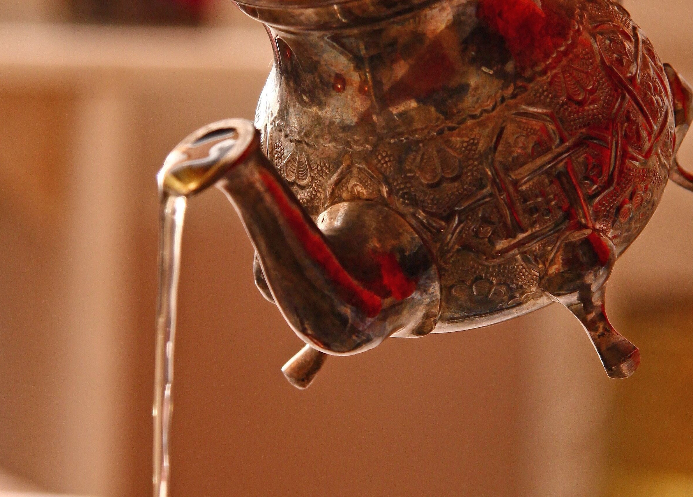 Intricately designed traditional teapot pouring at Ayana Spa Muscat, Muscat Governorate, OM.