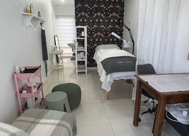 Interior of Gentle Radiance Beauty Salon in Gqeberha, Eastern Cape, ZA featuring treatment bed and decor.