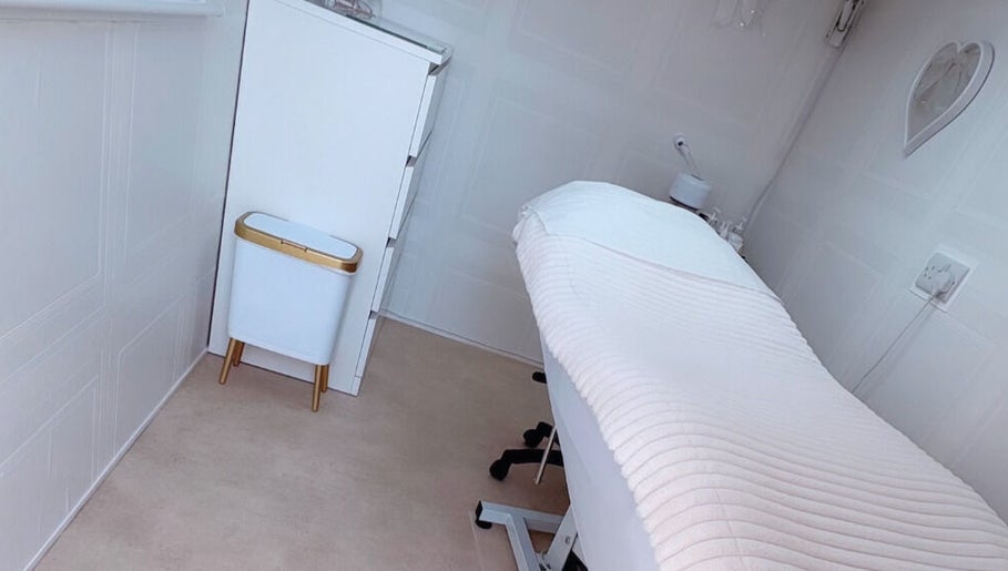 Elegant treatment room at Bows Beauty & Aesthetics, Bognor Regis, England, GB with plush white decor.