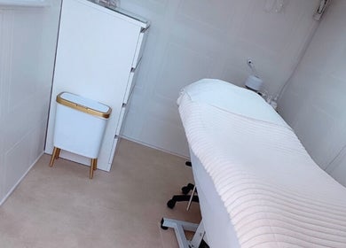 Elegant treatment room at Bows Beauty & Aesthetics, Bognor Regis, England, GB with plush white decor.