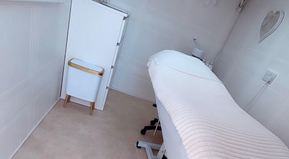 Elegant treatment room at Bows Beauty & Aesthetics, Bognor Regis, England, GB with plush white decor.