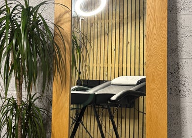 Contemporary salon setup with mirror and chair at KIKI Beauty, Sheffield, England, GB.