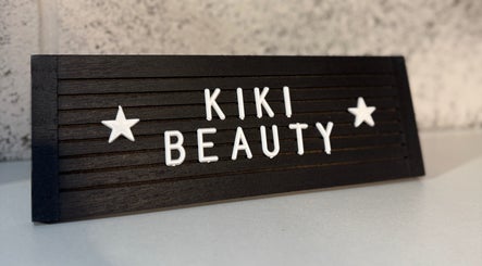 KIKI Beauty logo on a sleek black sign at Sheffield, England, GB, capturing elegance and style.