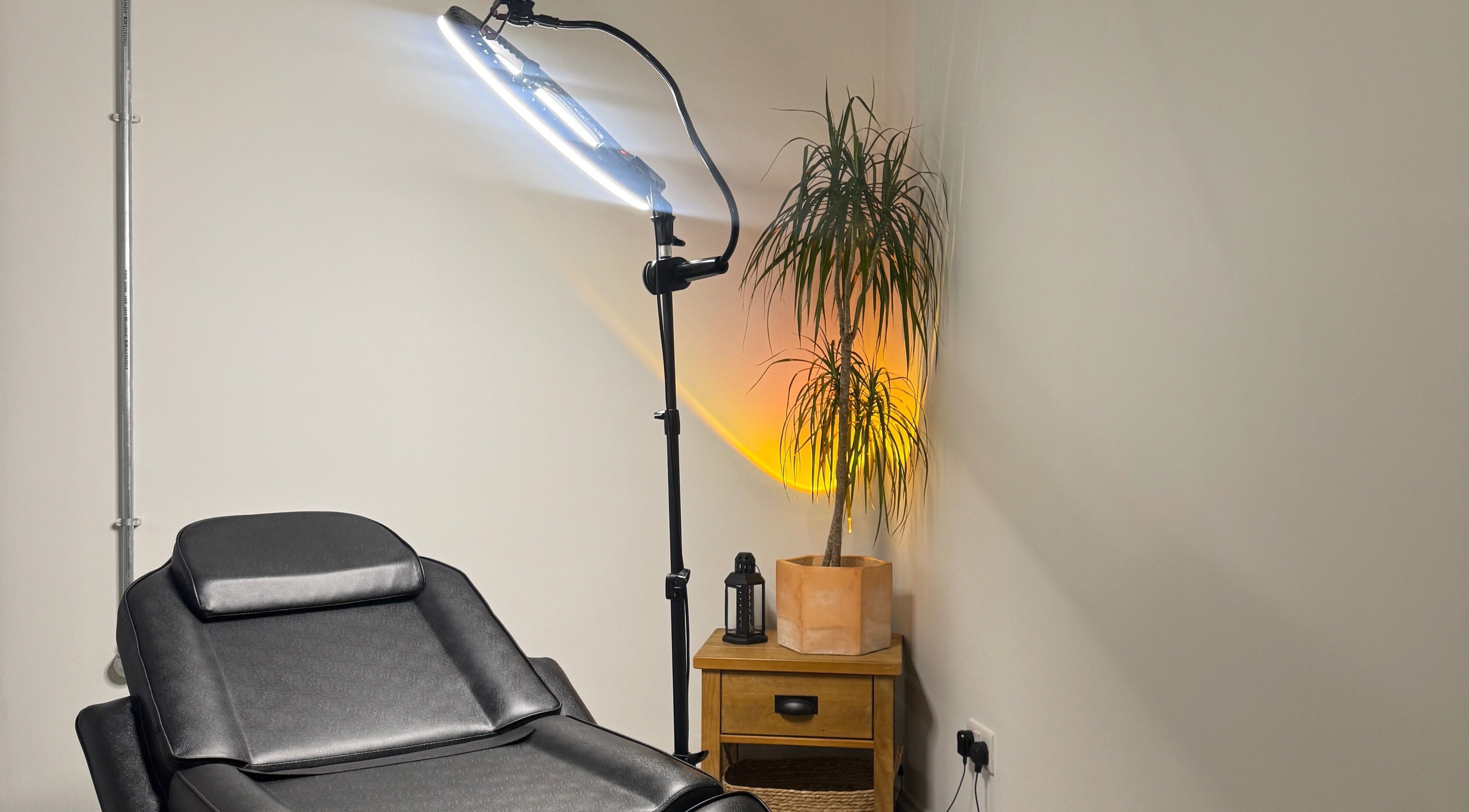 Cosy treatment room at KIKI Beauty with a black chair and plant in Sheffield, England, GB.