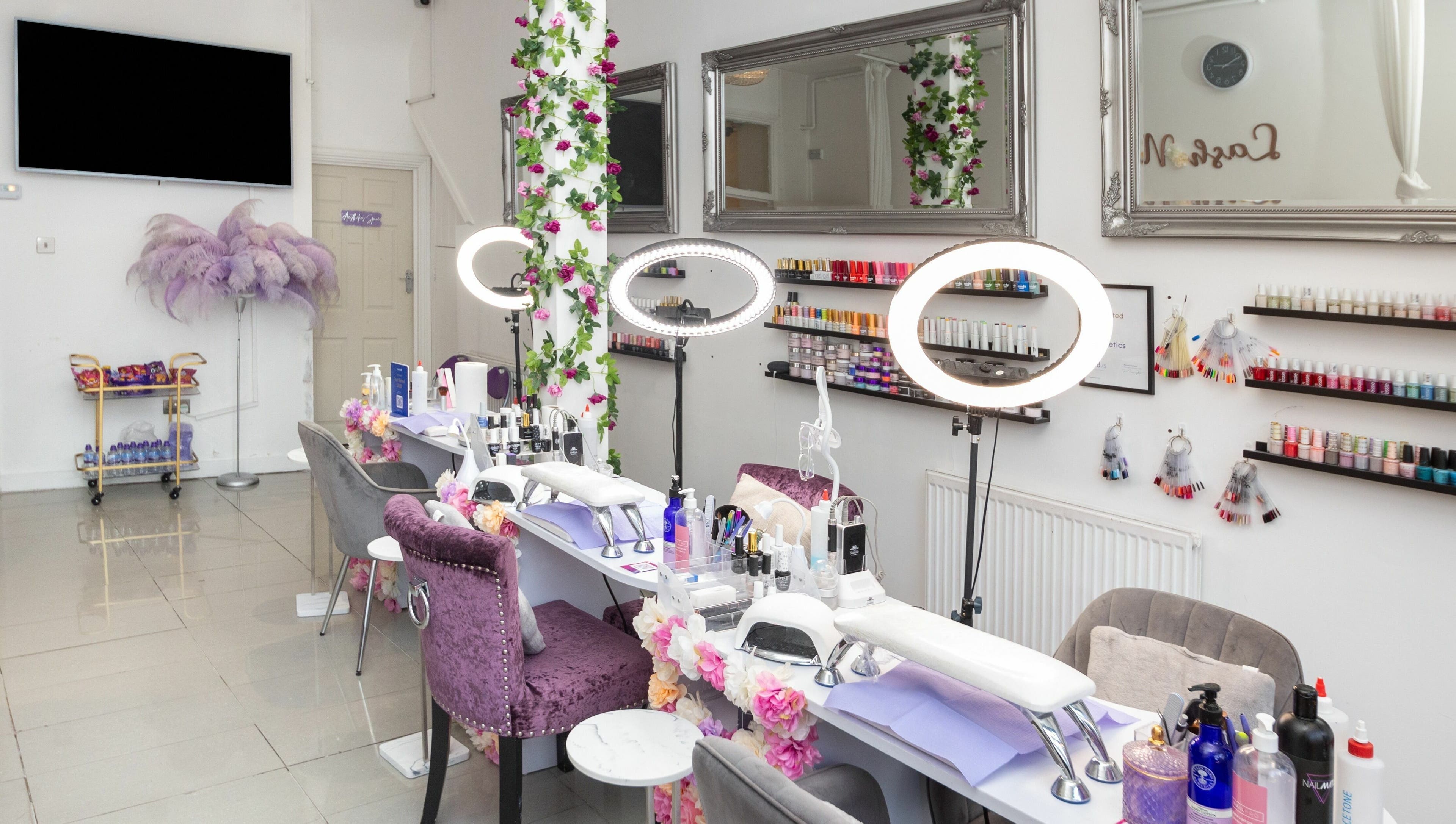 Glamorous nail studio at 10:15 Aesthetics, London, England, GB. Elegant setting with manicure stations and polish displays.