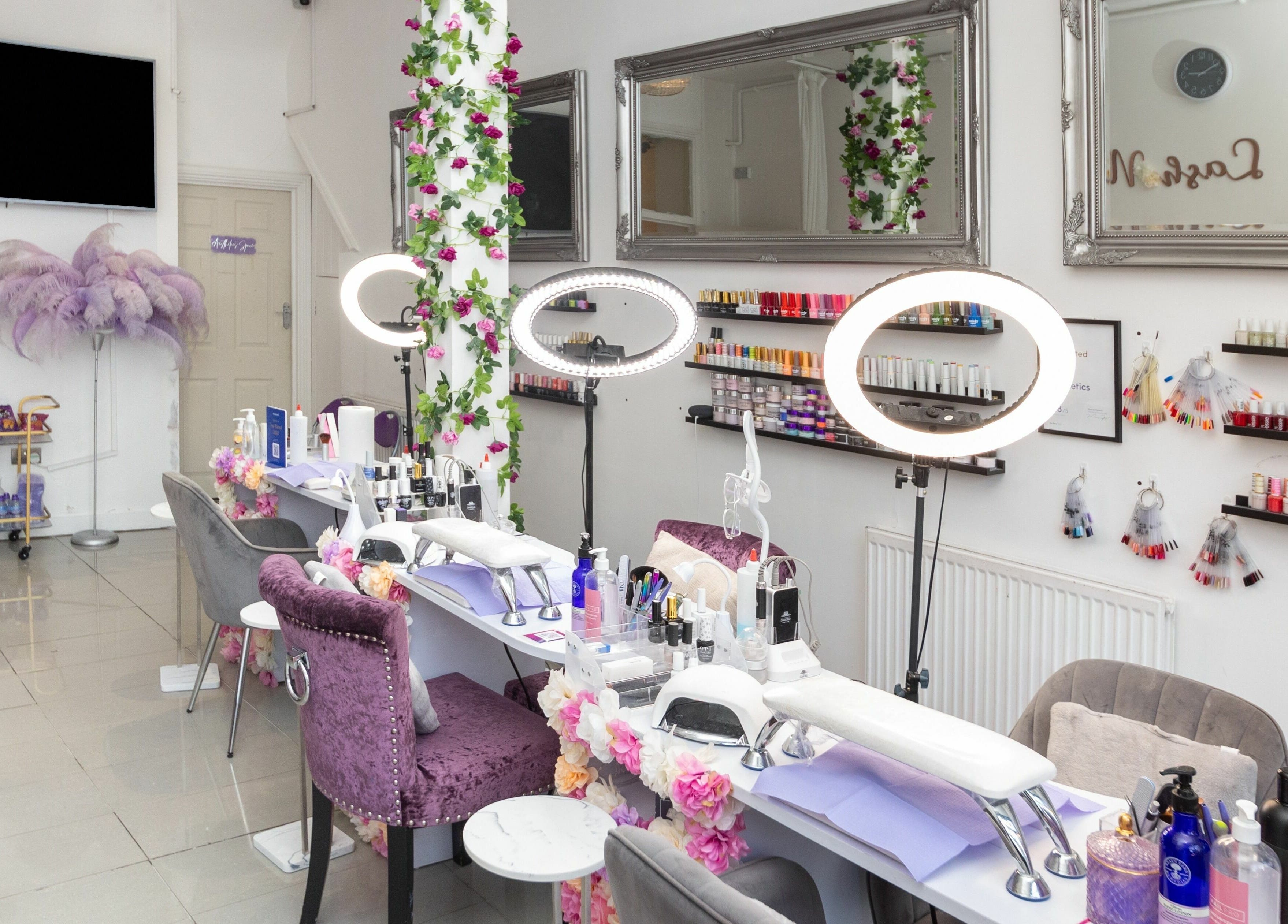 Glamorous nail studio at 10:15 Aesthetics, London, England, GB. Elegant setting with manicure stations and polish displays.