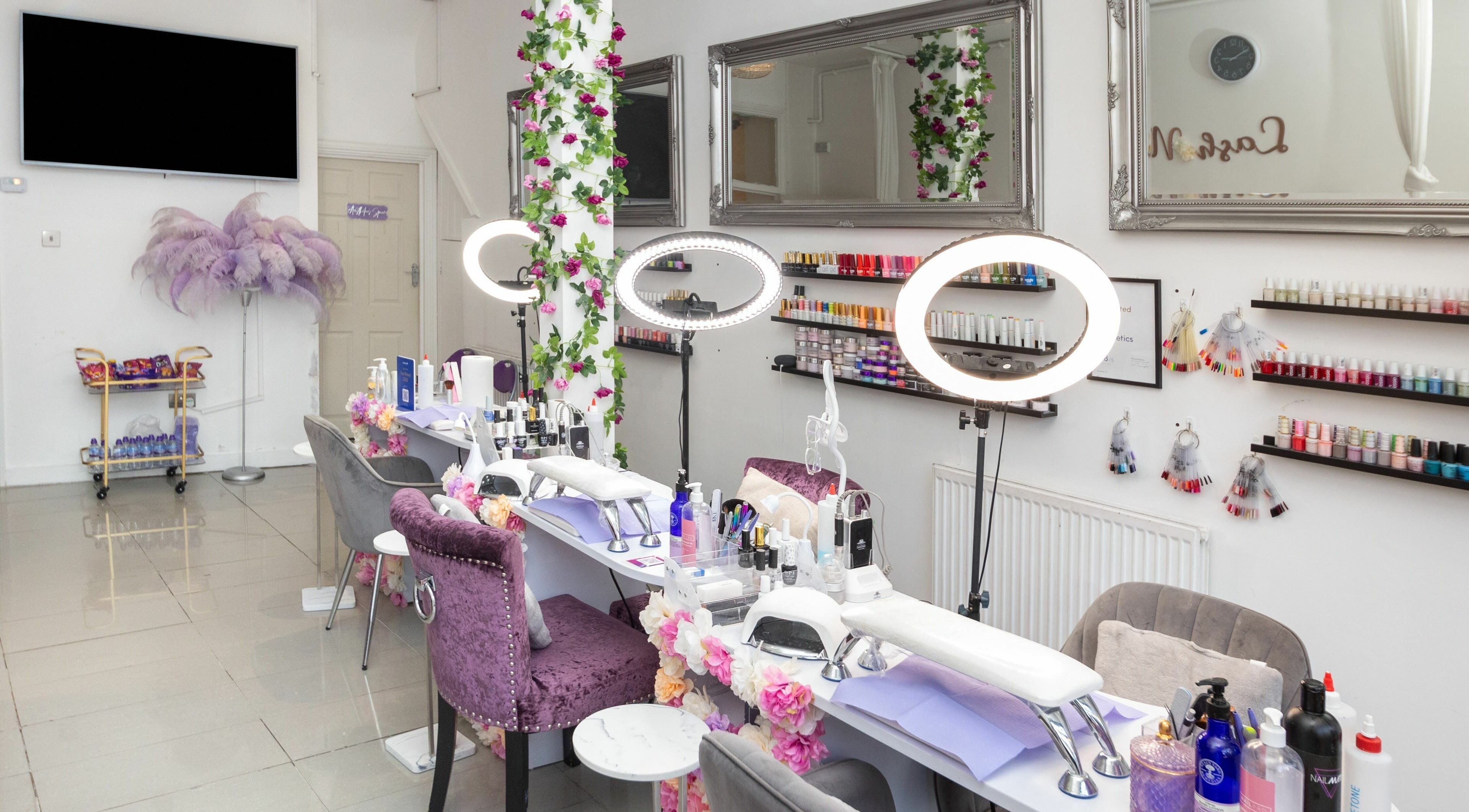 Glamorous nail studio at 10:15 Aesthetics, London, England, GB. Elegant setting with manicure stations and polish displays.