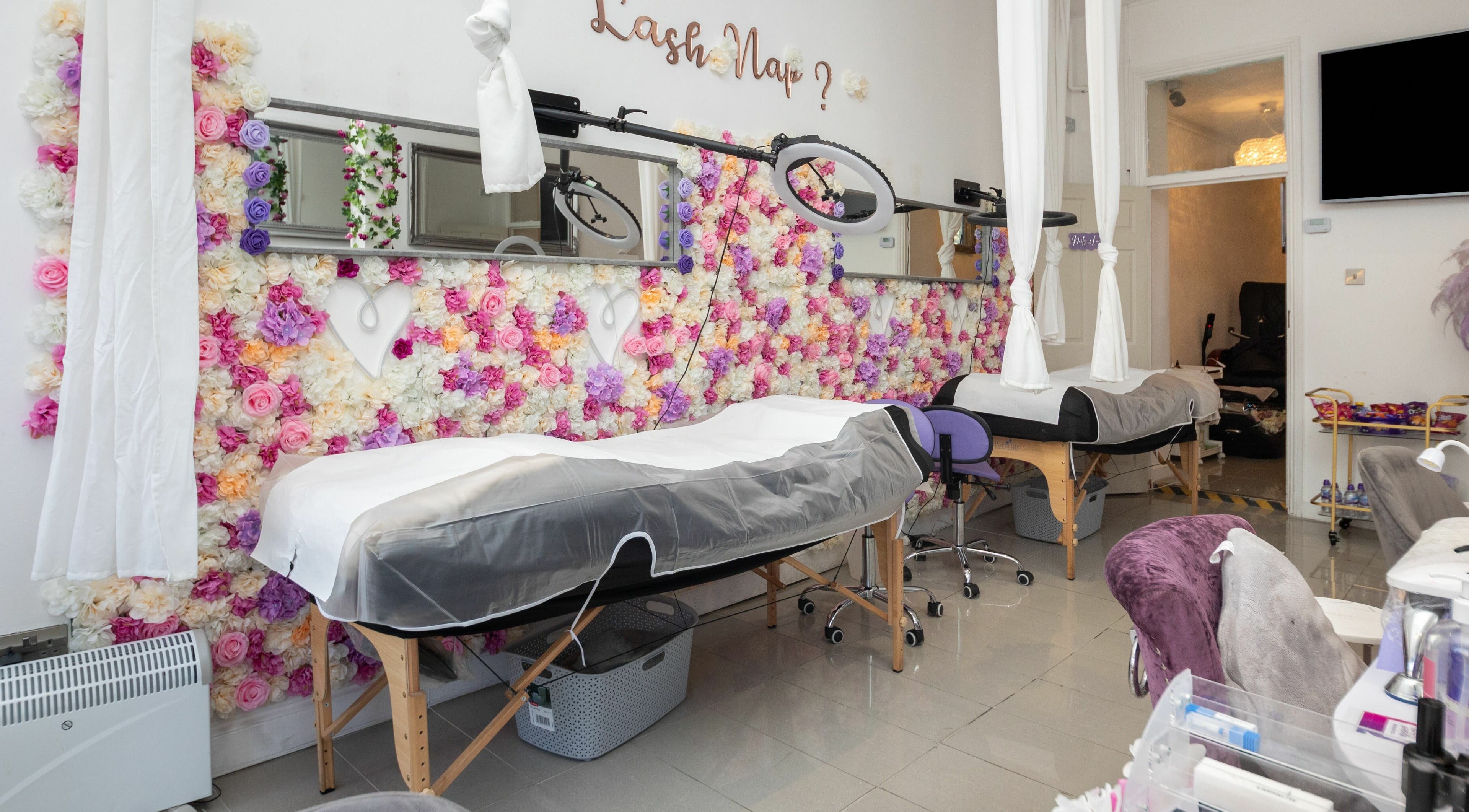 Luxurious treatment room at 10:15 Aesthetics in London, England, GB with floral decor and modern equipment.