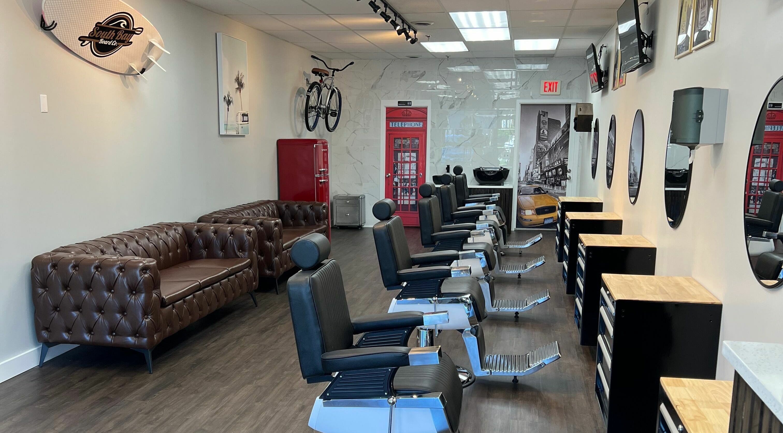 Stylish interior of Art Zone Barbering in Massachusetts featuring classic barber chairs and decor.